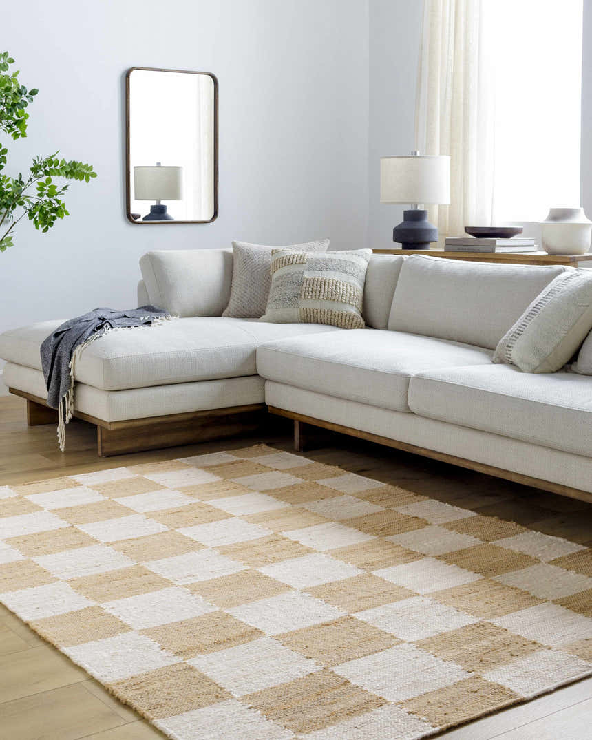 Living room with a light sectional sofa and Kamey Handmade Becki Owens x LIVABLISS rug in a light brown and white checkerboard pattern. Roomscene-Rectangle