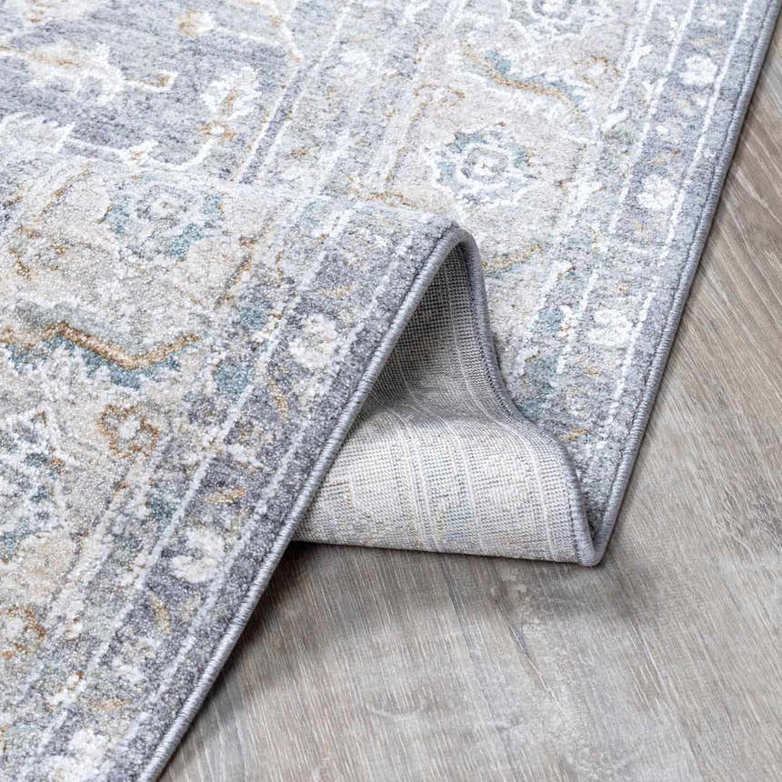 Close-up of the Ulubey Distressed Gray Thick Luxe Area Rug, showing its traditional pattern, soft texture, and gray color palette. Fold