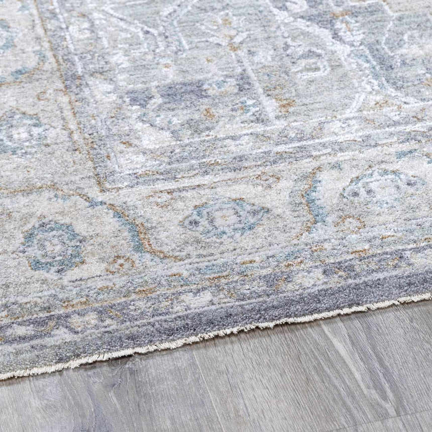 Close-up of the Ulubey Distressed Gray Thick Luxe Area Rug showing its oriental pattern, texture, and gray, blue, and beige tones. Pile