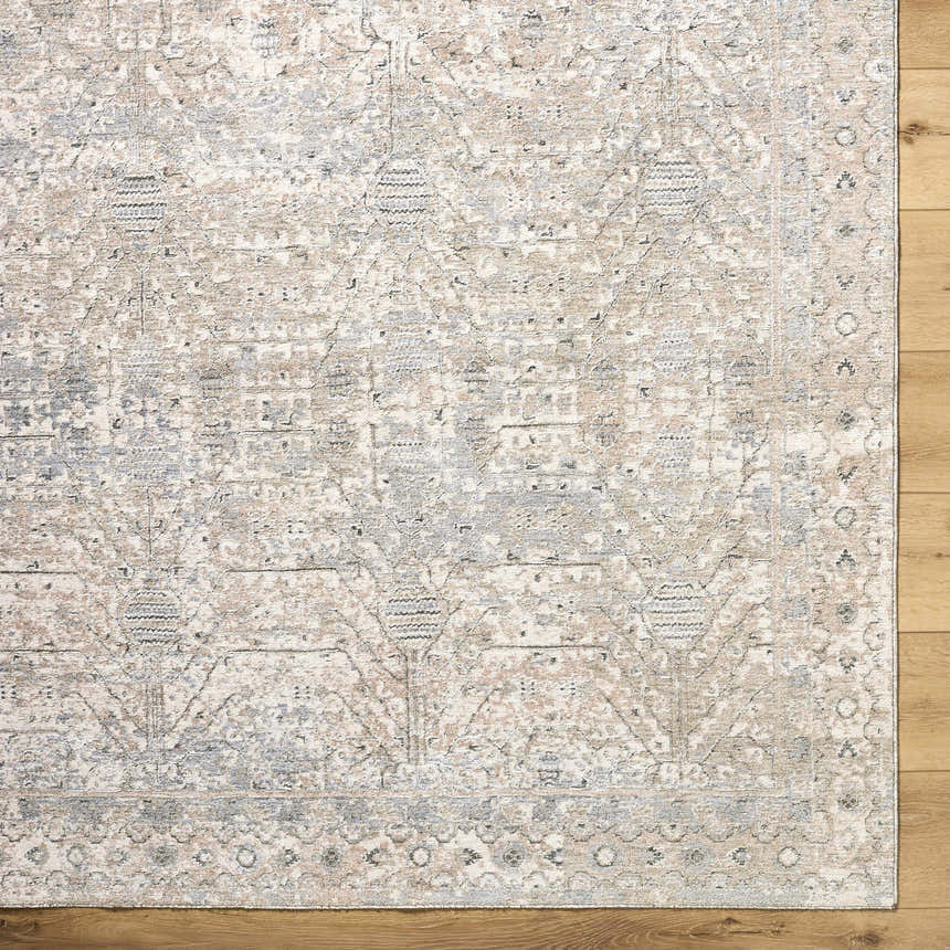 Close-up of the Avalyn Area Rug. Cream, light sage, light slate, and tan farmhouse traditional rug design. Corner