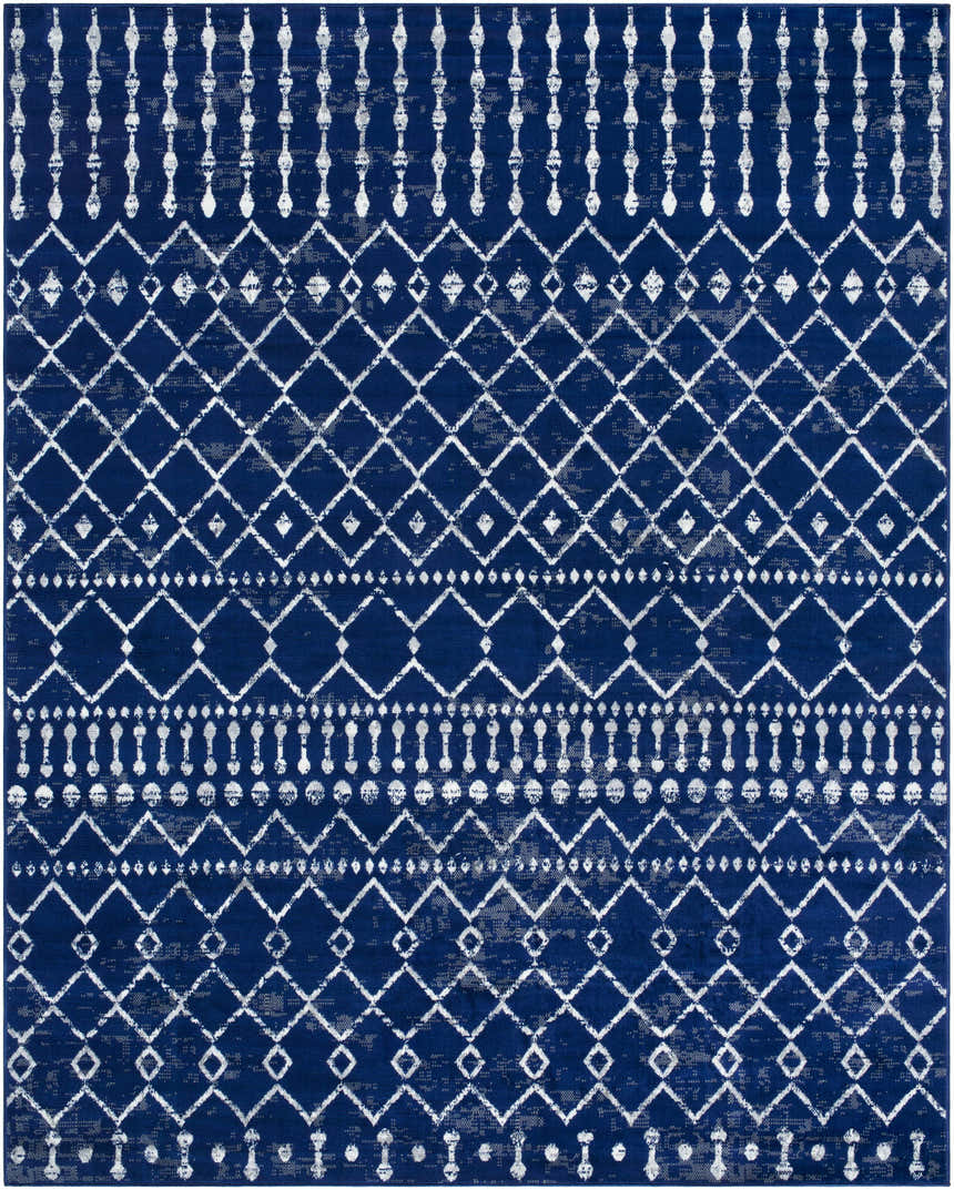 Close-up of the Varun Area Rug, a machine-woven rug with a blue and white bohemian-inspired geometric pattern. Design-Rectangle