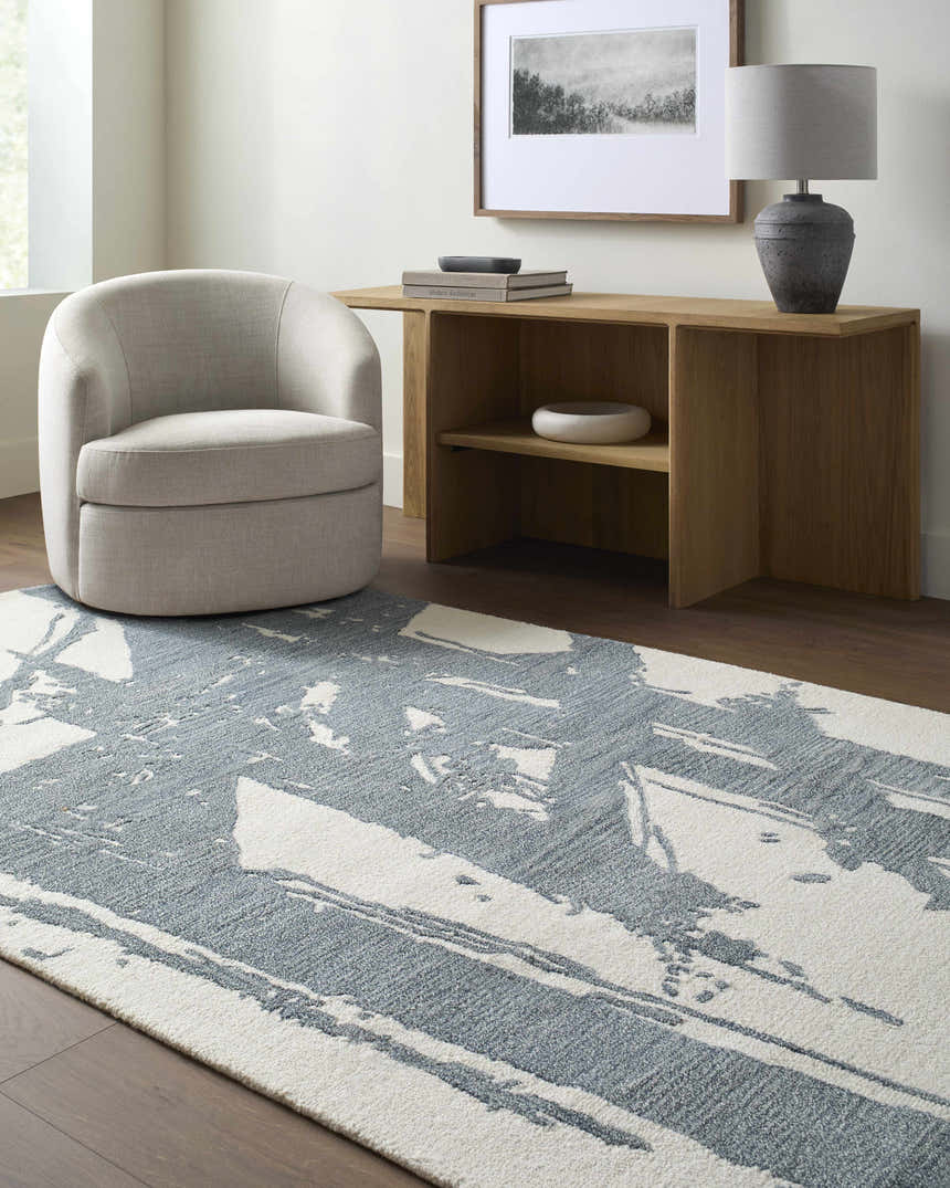 Living room scene with a Viven Slate Blue Area Rug, light wood console table, and gray swivel chair. Roomscene-Rectangle