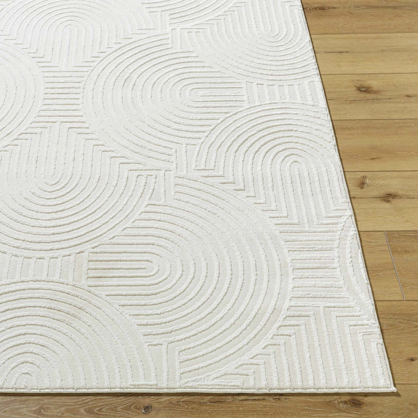 Close-up of the Aucoin Cream 3D Rainbow Washable Area Rug showing the textured geometric pattern on a wood floor. Front