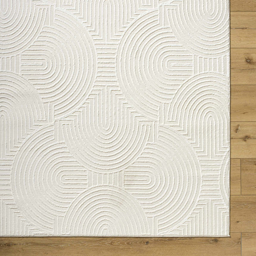 Close up of the Aucoin Cream 3D Rainbow Washable Area Rug. Cream rug with a raised geometric pattern. Swatch