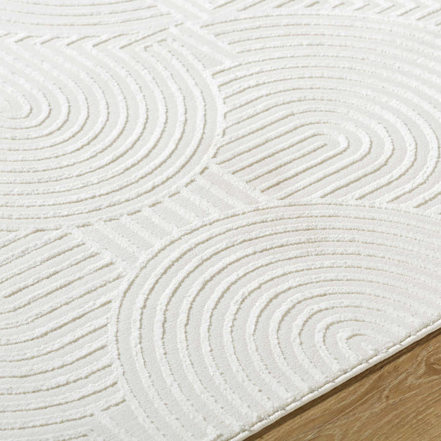 Close up of the cream Aucoin 3D Rainbow Washable Area Rug showing the textured, contemporary geometric pattern. Texture