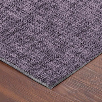 Close-up of the textured Dalyn Luxury Voyage VY1 Plum Washable Area Rug showing dark purple woven design.