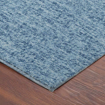 Close-up of the Dalyn Luxury Voyage VY2 Denim Washable Area Rug showing its blue textured pattern and soft fibers.