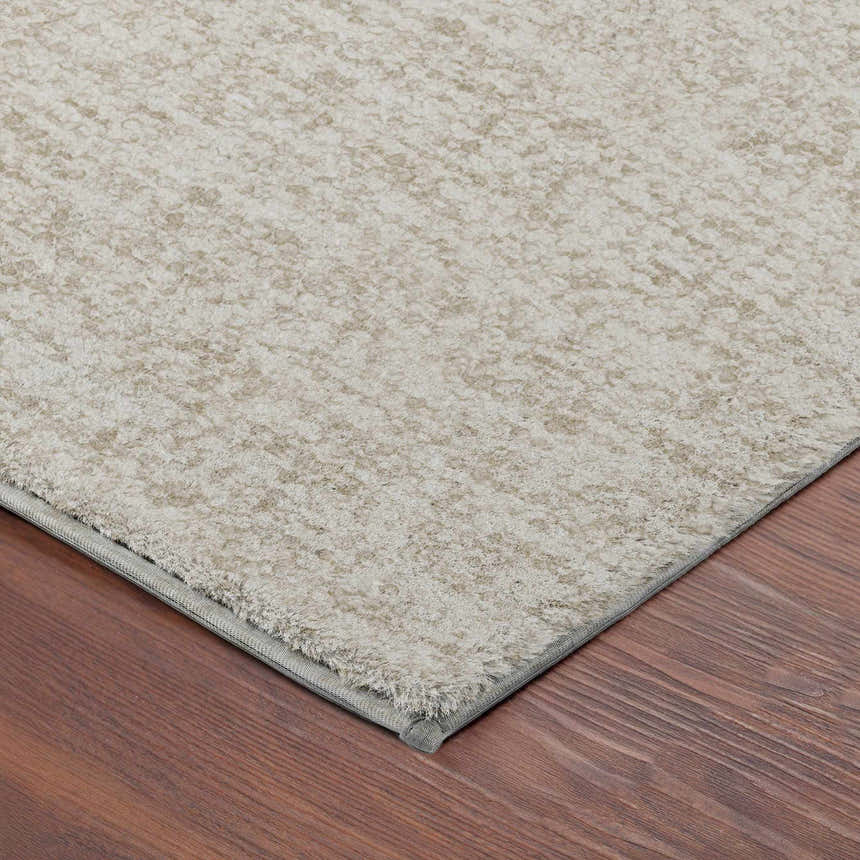 Close up of the beige Dalyn Luxury Voyage VY2 Linen Washable Area Rug showing texture and bound edge.