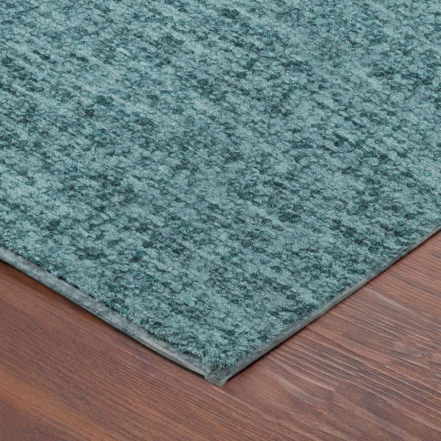 Close-up of the teal Dalyn Luxury Voyage VY2 Washable Area Rug showing its texture and subtle pattern.