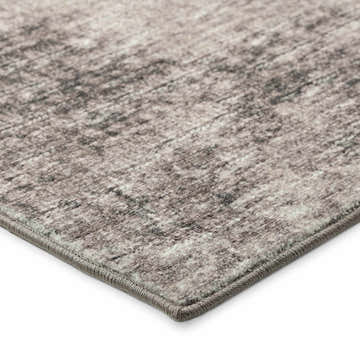 Close up of the taupe Dalyn Winslow WL1 rug, showing its beige, brown, and ivory abstract pattern and textured edge.