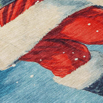 Close-up of Dalyn Wonderland WN15 Blue Washable Area Rug featuring red, off-white, and blue hues. Holiday style rug.