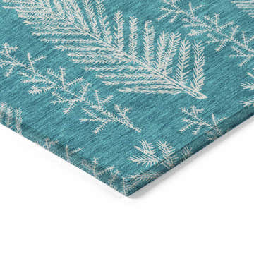 Close-up of Dalyn Wonderland WN21 Teal Washable Area Rug. Features a teal background and white holiday tree pattern.
