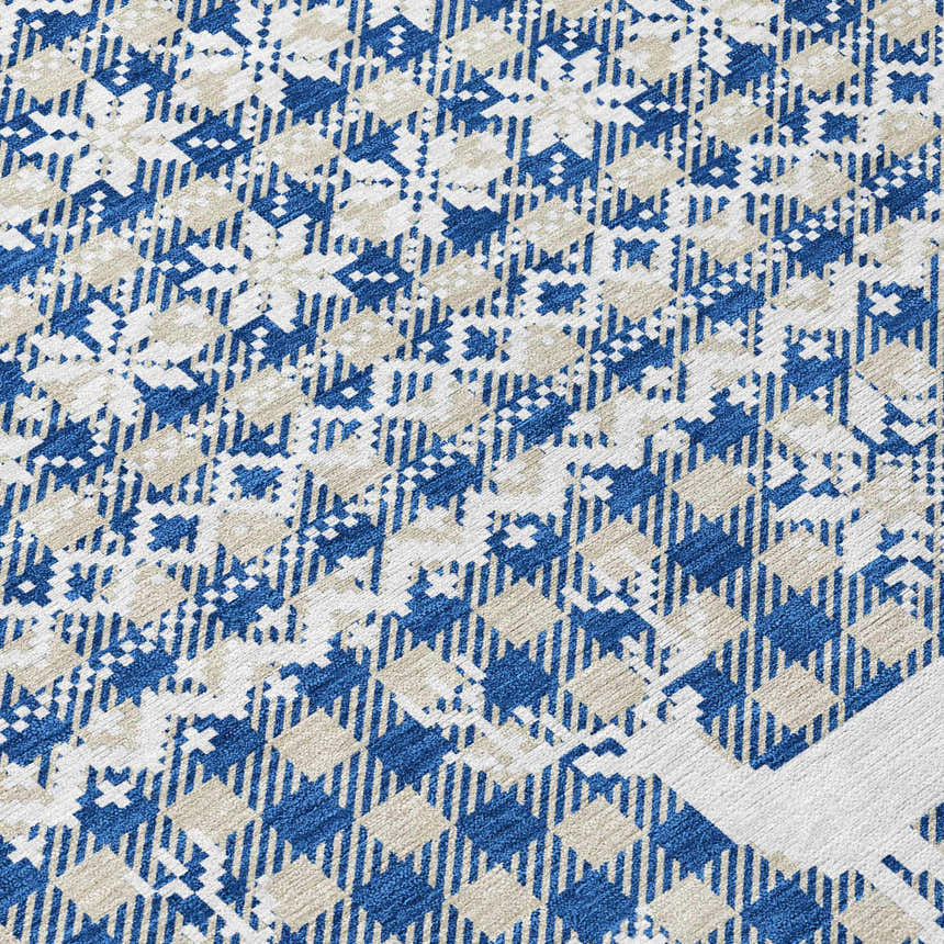 Close-up of Dalyn Wonderland WN28 Navy Washable Area Rug. Features a blue and beige geometric pattern. Machine-made texture.