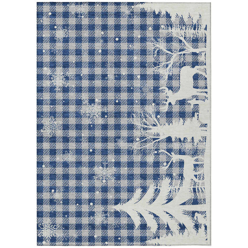 Close-up of Dalyn Wonderland WN32 Blue Washable Area Rug. Features a blue plaid pattern with snowflakes and a white tree design.