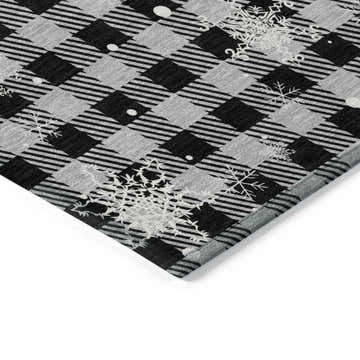 Close-up of Dalyn Wonderland WN32 Gray Washable Area Rug. Black and gray plaid with white snowflake pattern. Holiday style.