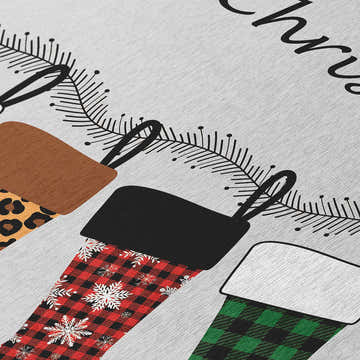 Close-up of Dalyn Wonderland WN5 Silver Washable Area Rug featuring holiday stocking patterns in red plaid, leopard print, and green plaid.