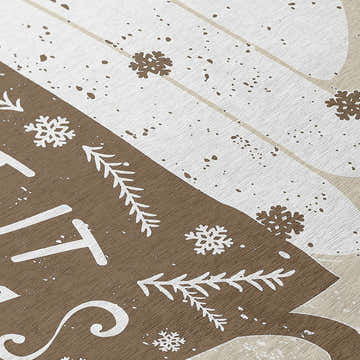 Close-up of the Dalyn Wonderland Beige Washable Area Rug showing snowflake and tree pattern in beige, chestnut, and light brown.