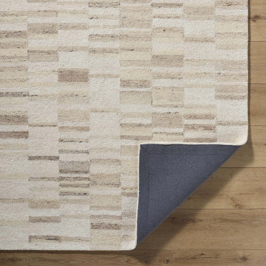 Close-up of the Max Handmade Becki Owens x LIVABLISS BOMX-2302 Area Rug. Beige, cream, and taupe geometric design. Fold