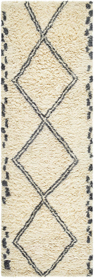 Close-up of the Audrey Area Rug; a hand-tufted wool rug with a charcoal diamond pattern on an ivory background. Design-Runner