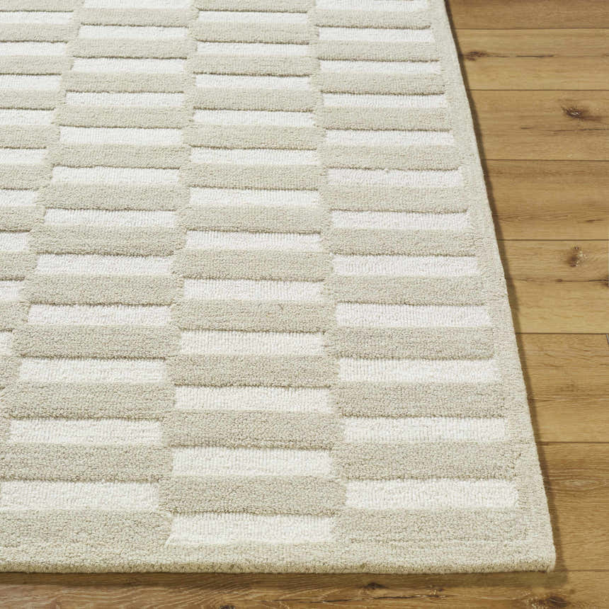 Close-up of the hand-tufted Uther Area Rug. Beige and cream wool rug with a contemporary striped pattern. Front