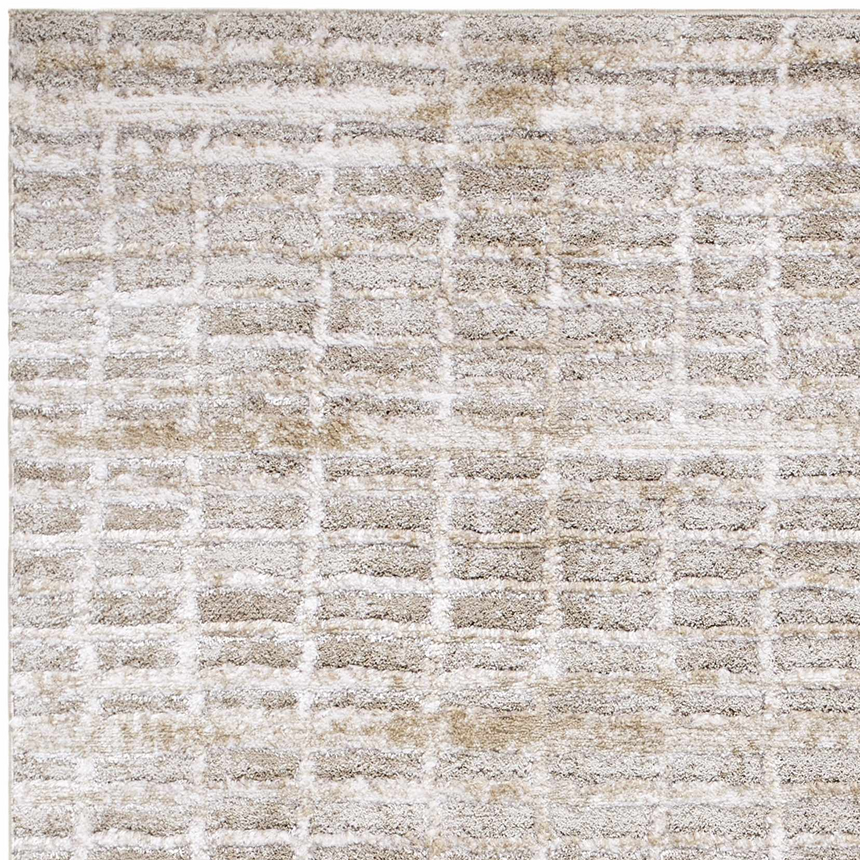 Close-up of the Ayashe Shag Area Rug. Light beige, off white, and tan shag rug with a subtle geometric pattern. Soft texture. Texture