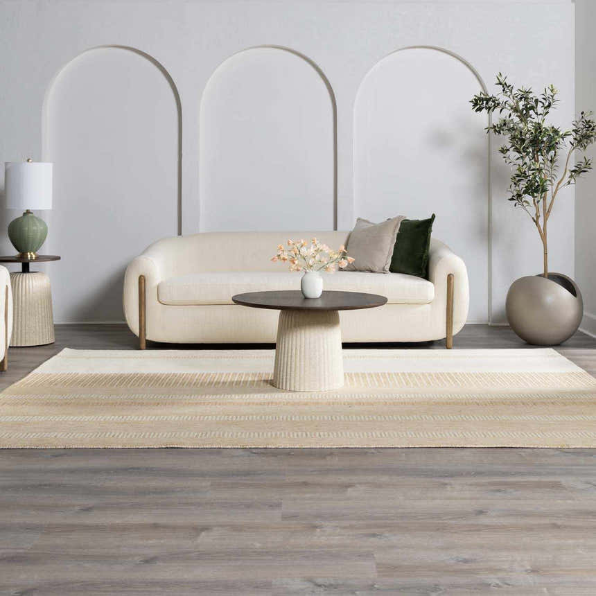 Living room scene with a neutral sofa and the Yoyko Area Rug in ash, pearl, prairie dust, and tan. Farmhouse style. Roomscene-Rectangle