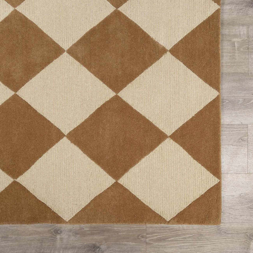 Close-up of the Aradia Tan Area Rug, a hand-tufted wool rug with a tan and beige diamond pattern. Swatch