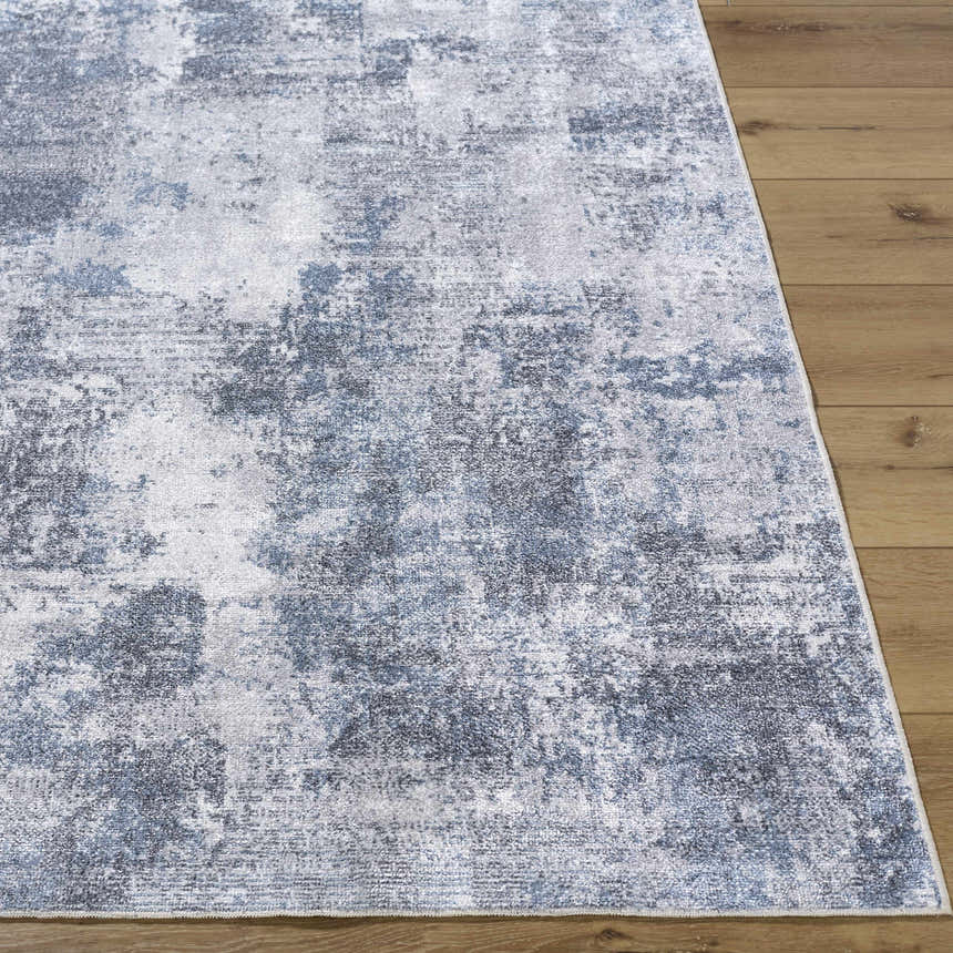 Close-up of the Anitra Off White Washable Area Rug. Contemporary style rug with navy and off white abstract pattern. Front