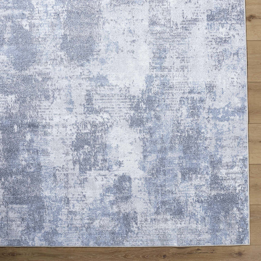Close-up of Anitra Off White Washable Area Rug. Contemporary style with navy and off-white abstract pattern. Swatch