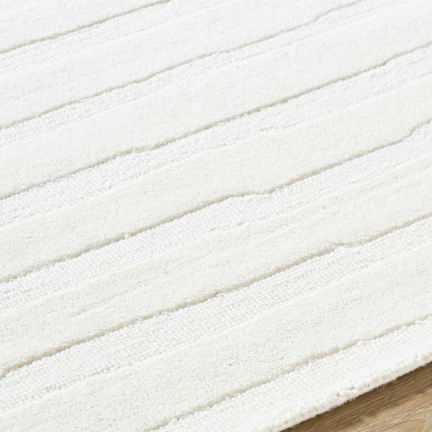 Close up of the textured, striped design of the Zerah White Wool Area Rug. Texture