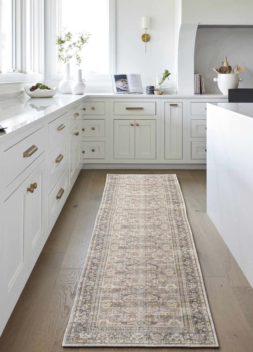 Bright kitchen with white cabinets and wood floors featuring a Zahar Washable Area Rug runner. Roomscene-Runner