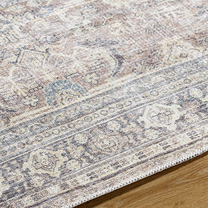 Close-up of the Zahar Washable Area Rug showcasing its traditional light silver, gray, and warm gray pattern and woven texture. Texture