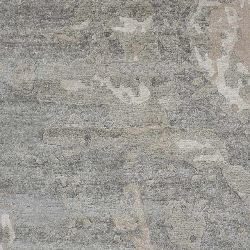 Close-up of the Nourison Silk Shadows Sand area rug, showing its sandstone colors, abstract pattern, and silk-like fiber texture.