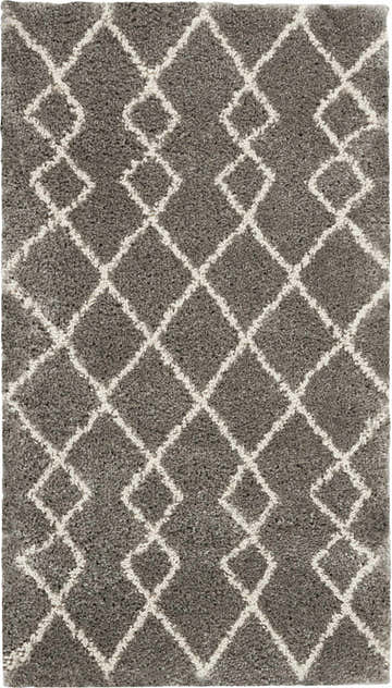 Close-up of the Nourison Martil Silver Moroccan shag rug, featuring a geometric diamond pattern in silver gray and white.