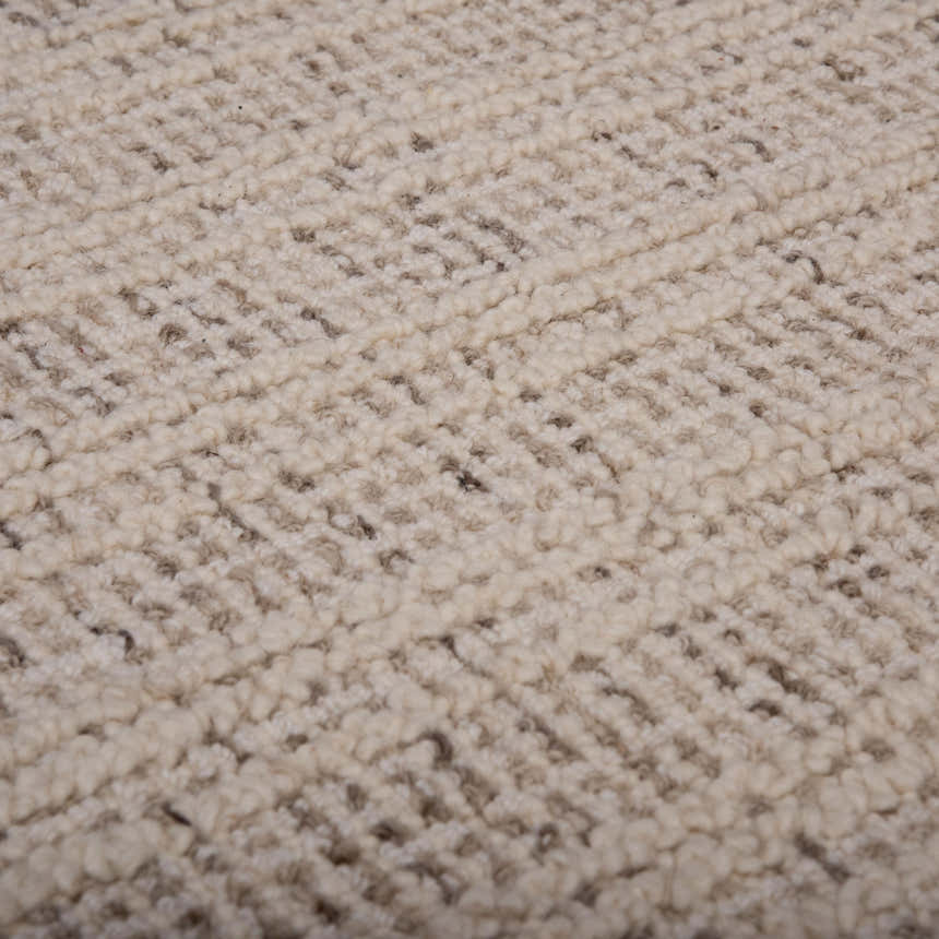 Close-up of the hand-tufted Rizzy A07203 area rug. Ivory wool with subtle dark red accents create a textured, contemporary design. Texture