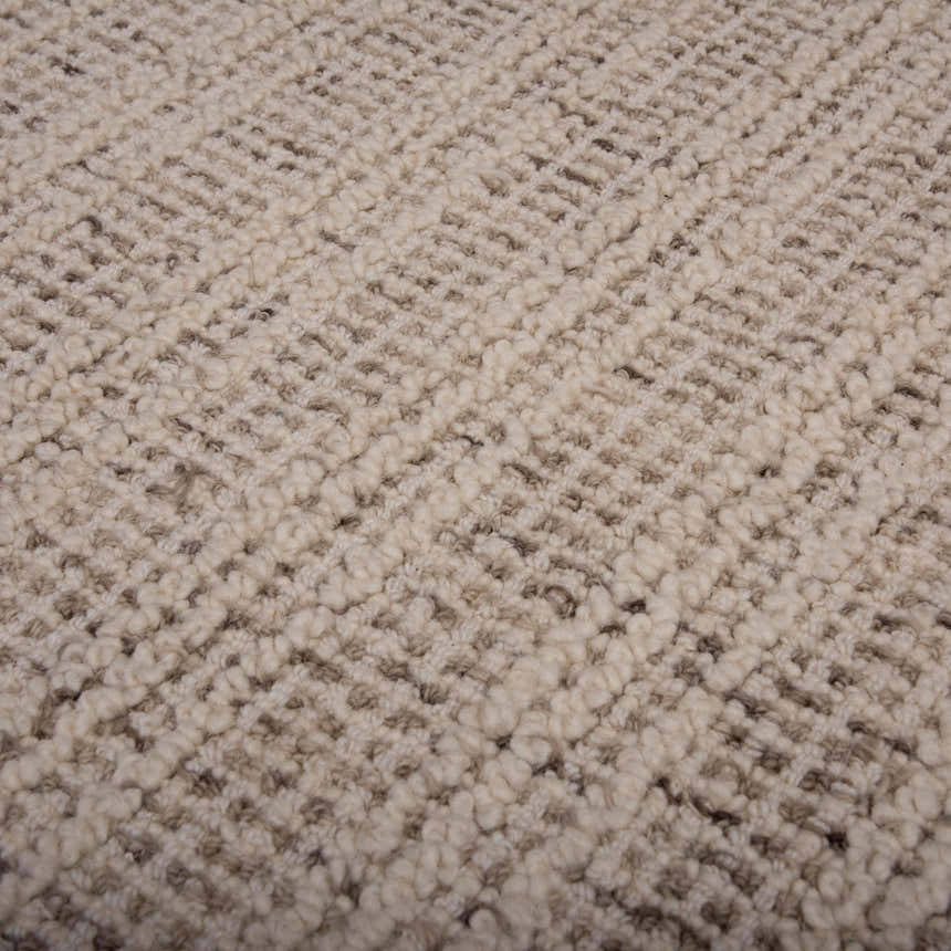 Close up of the hand-tufted Rizzy A07203 Area Rug. Ivory wool with a subtle, textured pattern. Texture