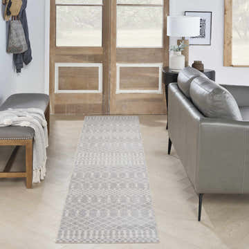 Entryway with gray leather sofa and Nourison Astra Grey Bohemian rug runner on light wood floors.