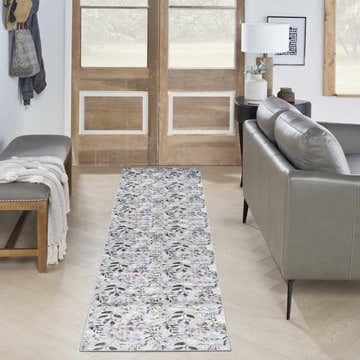 Entryway with grey leather sofa and Nourison Grey Multicolor Washable Area Rug runner.