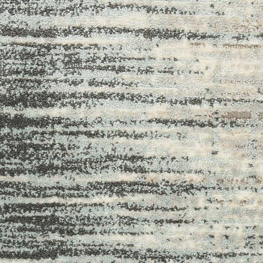Close-up of Nourison Marmara Teal/Grey rug showing its contemporary striped pattern and soft, textured weave.