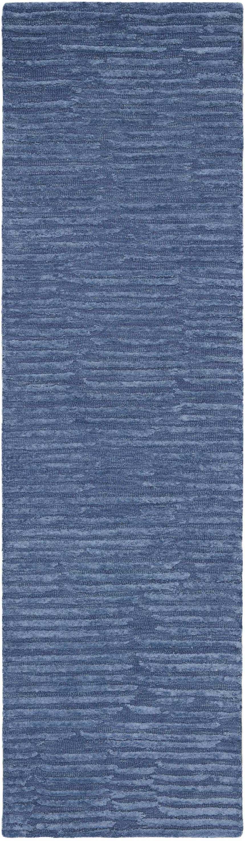 Close-up of Calvin Klein CK010 Linear Blue rug. Modern, handmade wool rug with a subtle horizontal stripe pattern.