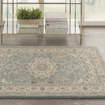 Close-up of the aqua, ivory, and chestnut Nourison Living Treasures Farmhouse rug with a floral pattern and soft texture.