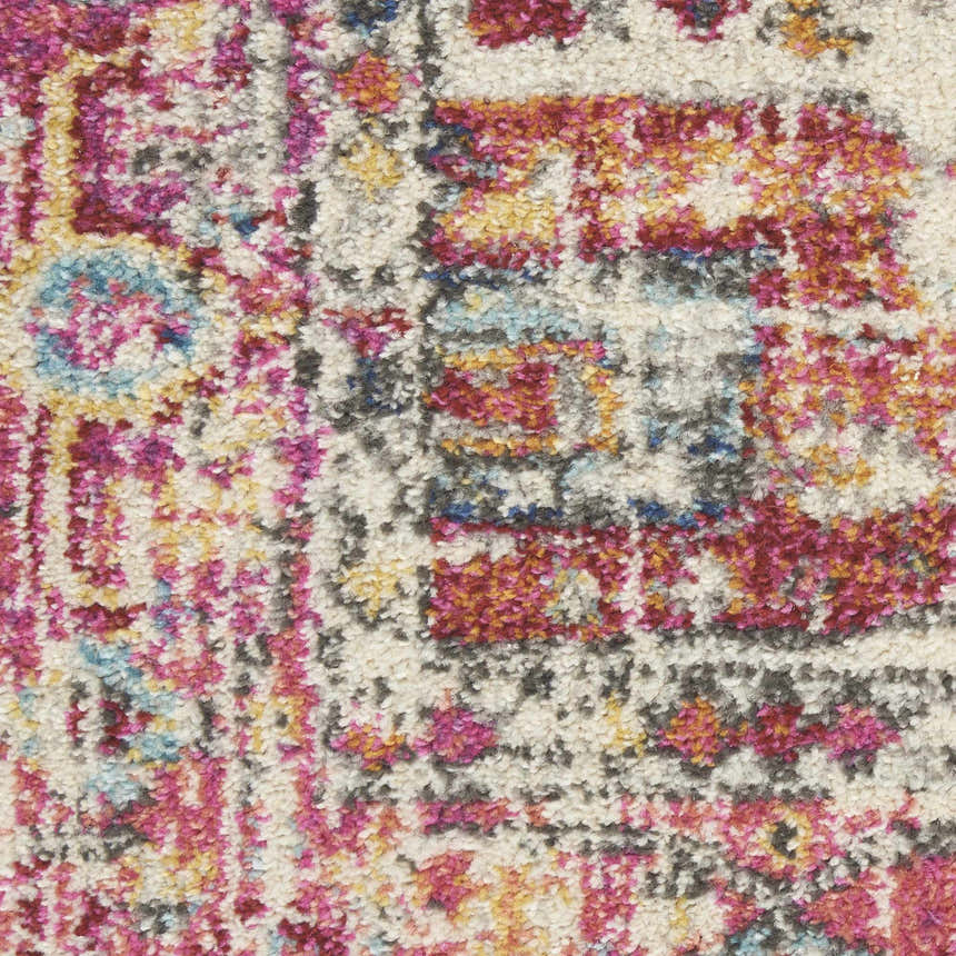 Close-up of the Nourison Passion Ivory Pink Bohemian rug, featuring a textured pile and chestnut, pink, and blue hues.