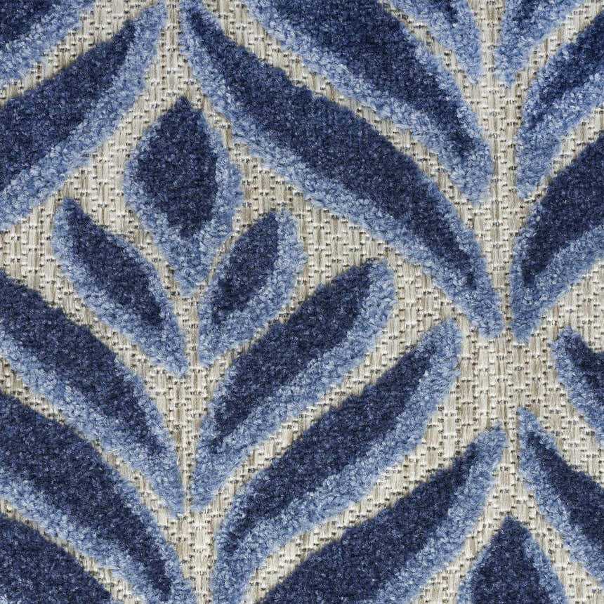 Close up of the Nourison Aloha Blue Outdoor Area Rug, featuring a leaf pattern in light and dark blue.