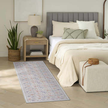 Farmhouse bedroom scene with Nourison Botanical Ivory Multicolor rug, wood floors, and neutral decor.