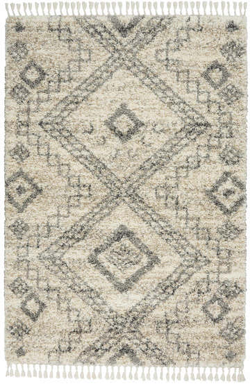 Close-up of Nourison Oslo Shag rug. Ivory and grey shag rug with diamond pattern and tassels. Soft, textured rug.