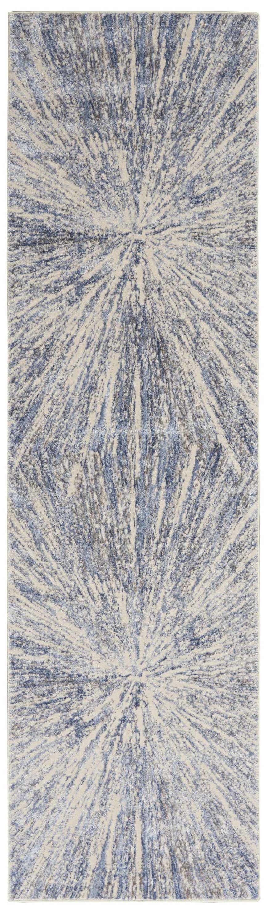 Close-up of Nourison Silky Textures Blue Grey rug. Modern design with radiating blue and gray pattern on a light background.