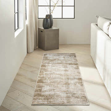 Modern living room with Calvin Klein CK078 Summit Mocha Ivory rug, light wood floors, and neutral furniture.