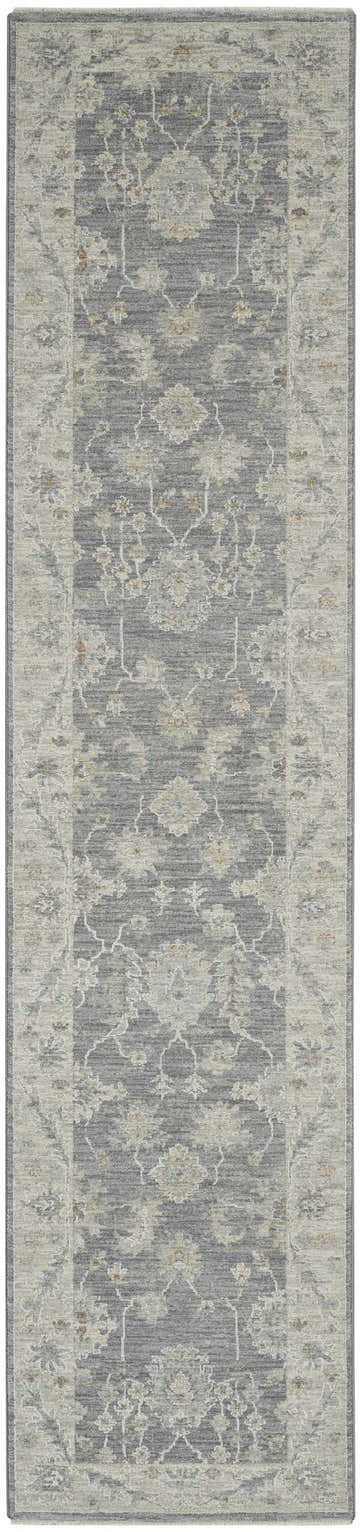 Close-up of the Nourison Infinite Charcoal Vintage Indoor Area Rug, a taupe and gray runner with a distressed floral pattern.