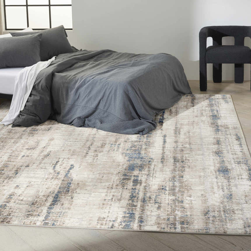 Modern bedroom with grey bedding and Calvin Klein CK022 Infinity Ivory Grey Blue rug, creating a calming, stylish space.