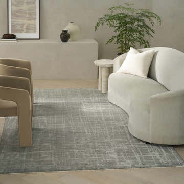 Modern living room with taupe chairs and Calvin Klein CK090 Latitude Slate rug, creating a calm, neutral space.